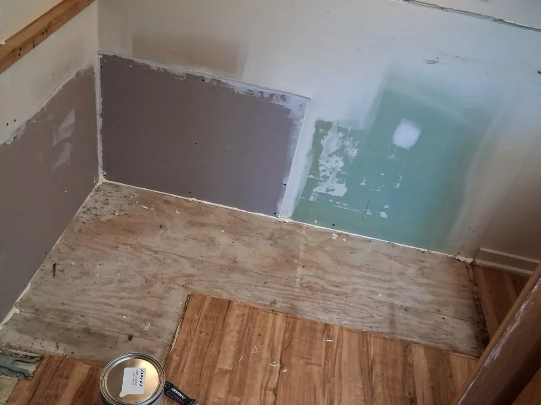 Drywall replacement and moisture remediation on interior wall with exposed framing