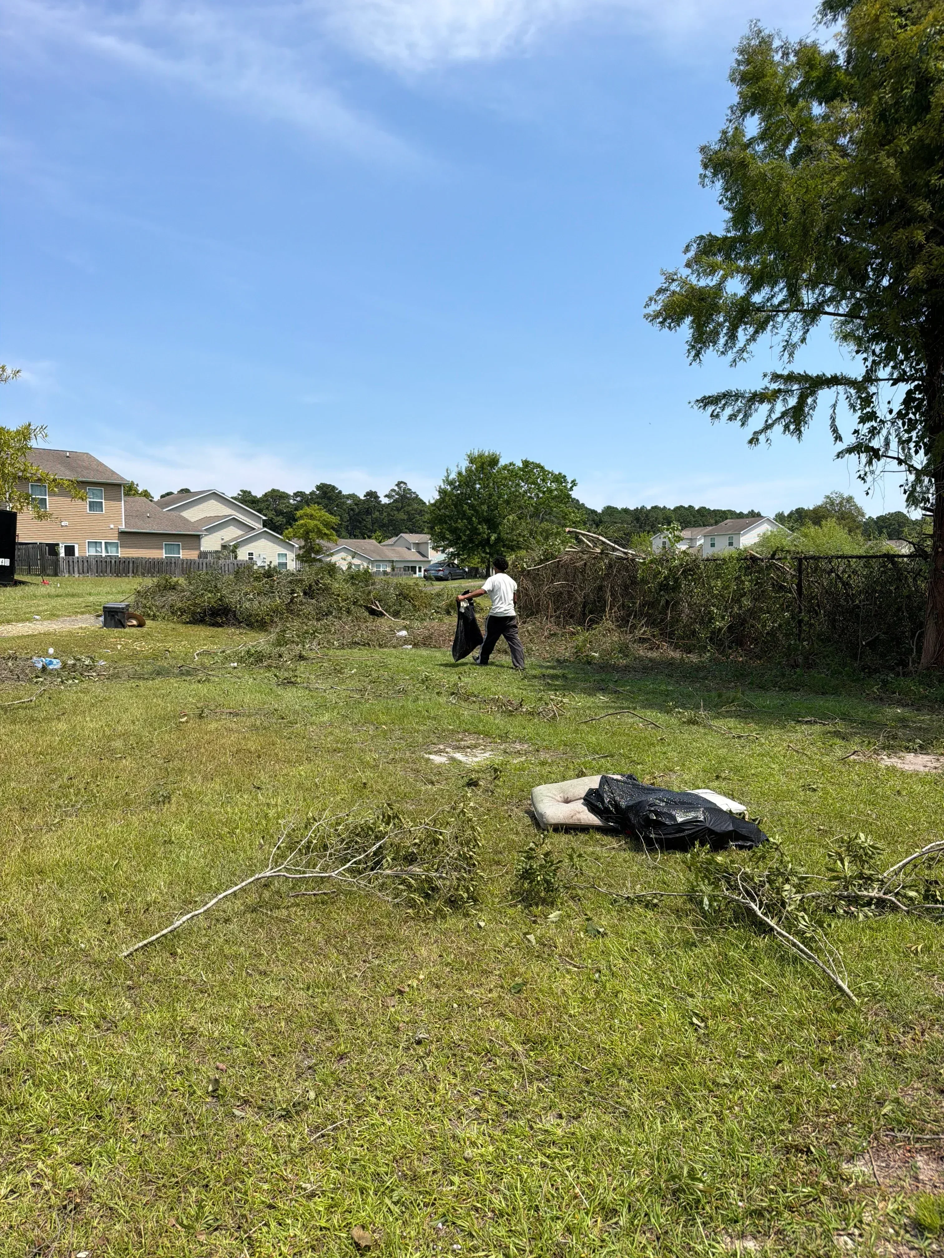 Residential property with graded landscape, drainage lines, and newly seeded lawn areas