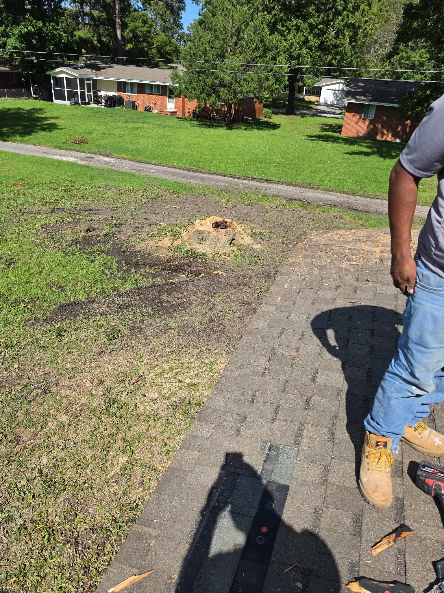 Exposed septic tank opening with damaged concrete ring and surrounding soil excavation